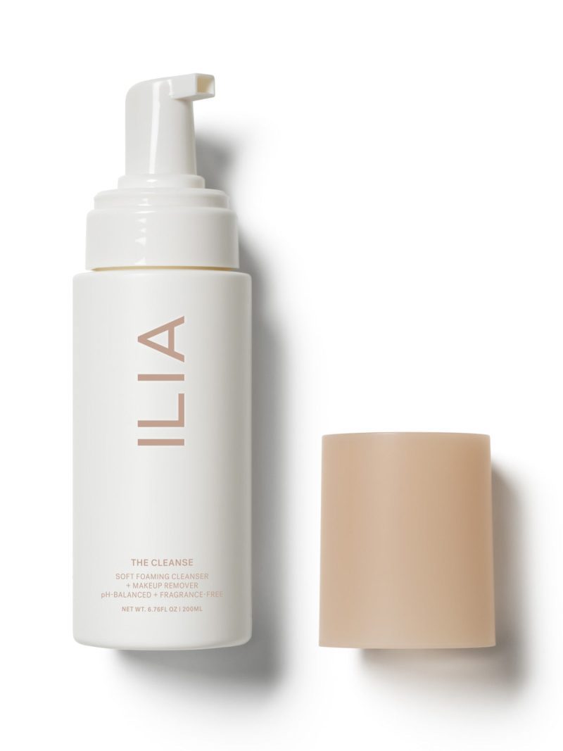 ILIA soft foaming cleanser bottle with its beige cap placed beside it.